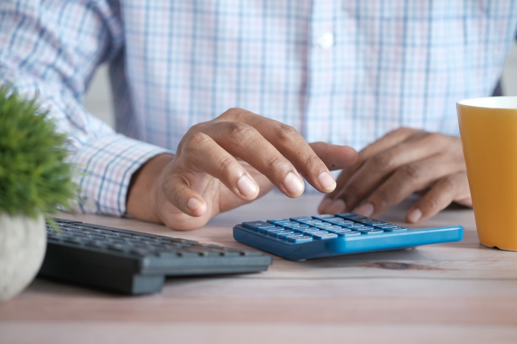 Hands working through numbers on a calculator