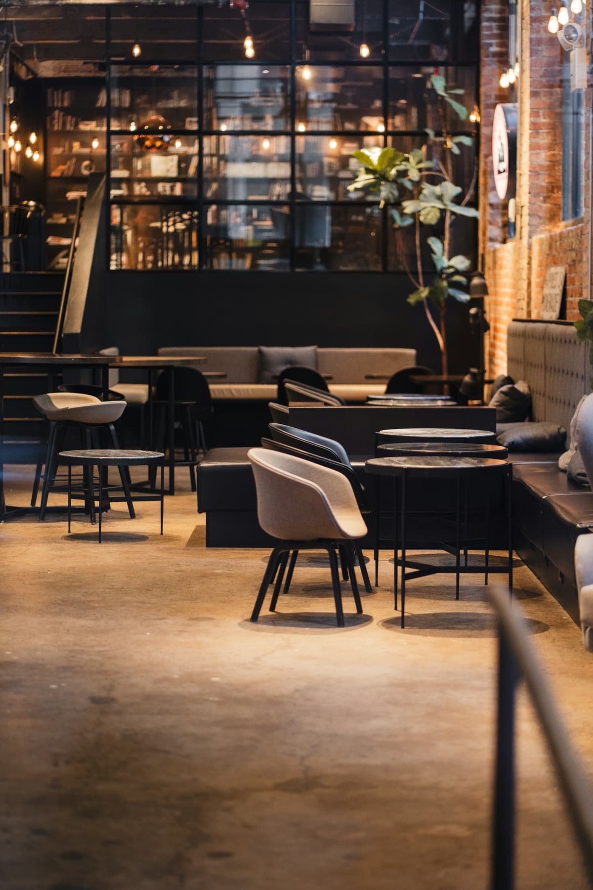 Cafe seating beside a large industrial window