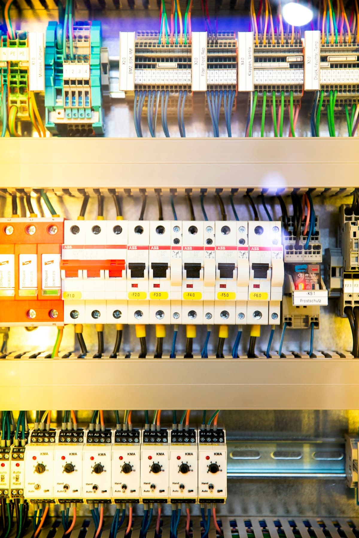 Tidy distribution board with rows of breakers and colour-coded wiring